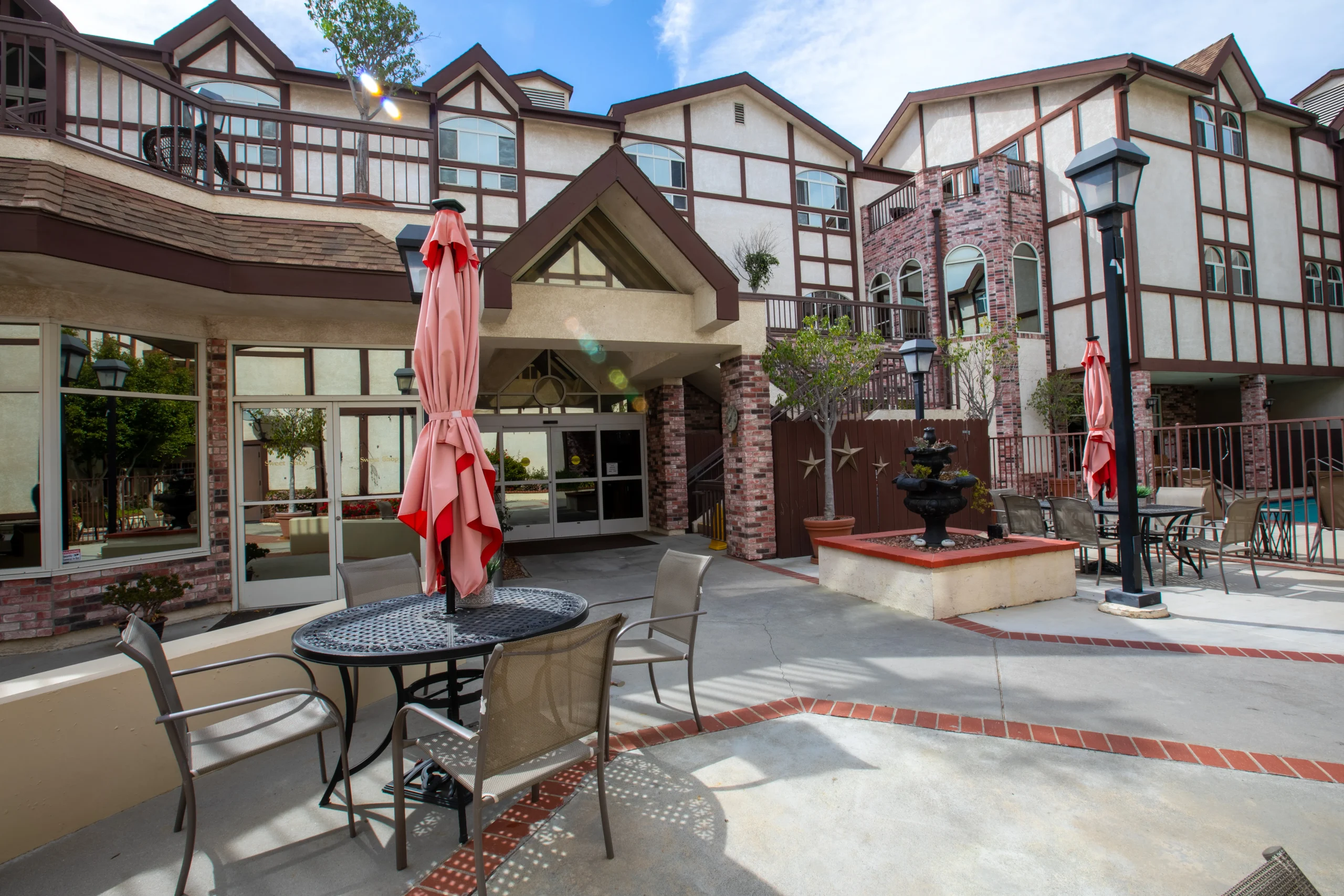 Outdoor seating area with umbrella by the building