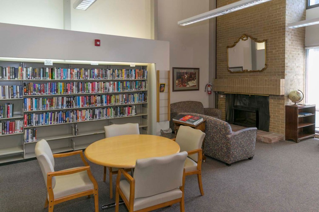 Interior view of a library common area with bookshelves and seating