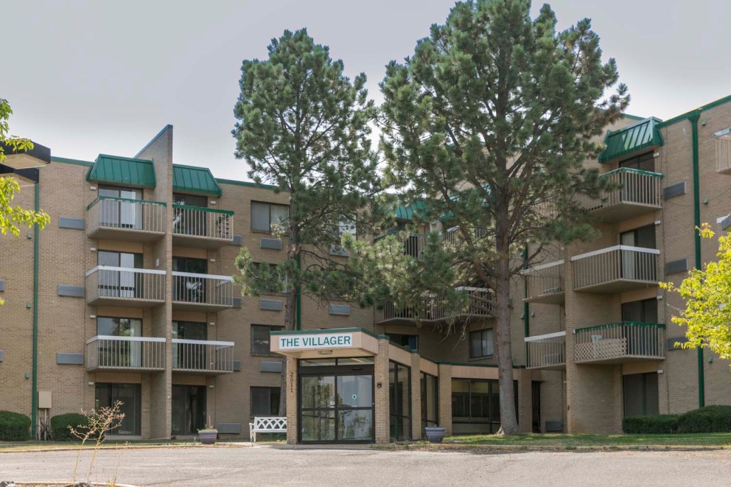 Exterior view of The Villager facility with green accents