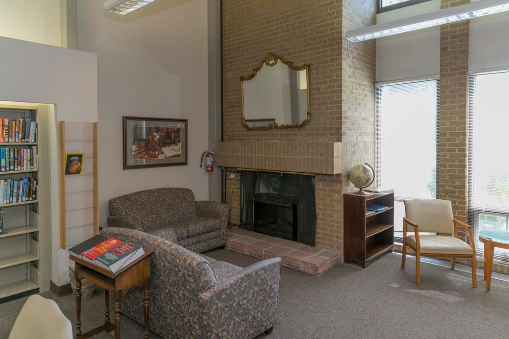Cozy common area with seating and bookshelves