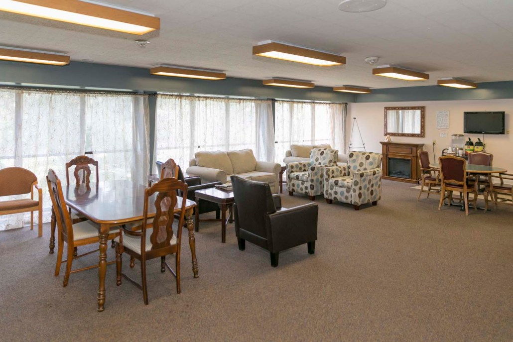 Bright common area with comfortable seating and dining tables