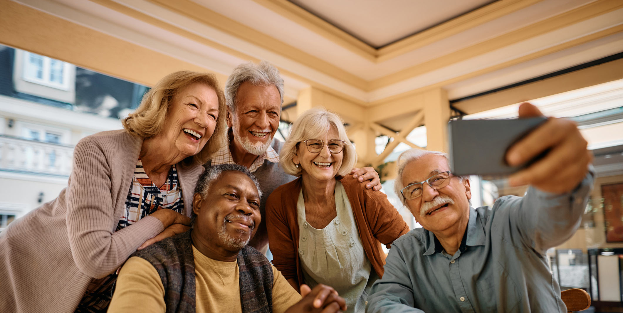 Residents enjoying a group selfie in a common area