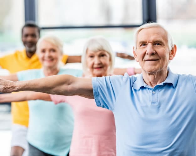 Seniors participating in a group exercise class