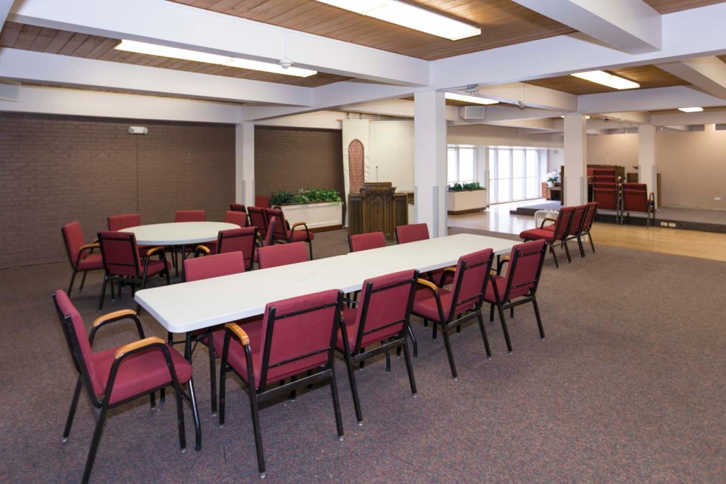 Common area with tables and chairs set up for activity