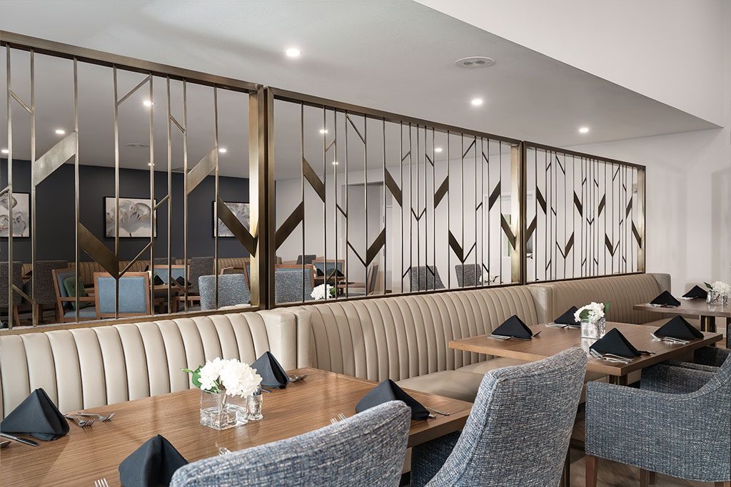 A dining area with elegant seating and table settings.