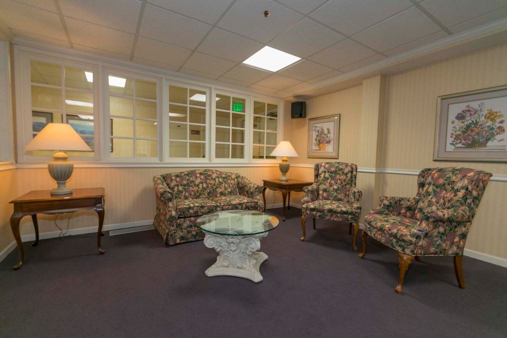 Cozy common area with floral furniture and lamps