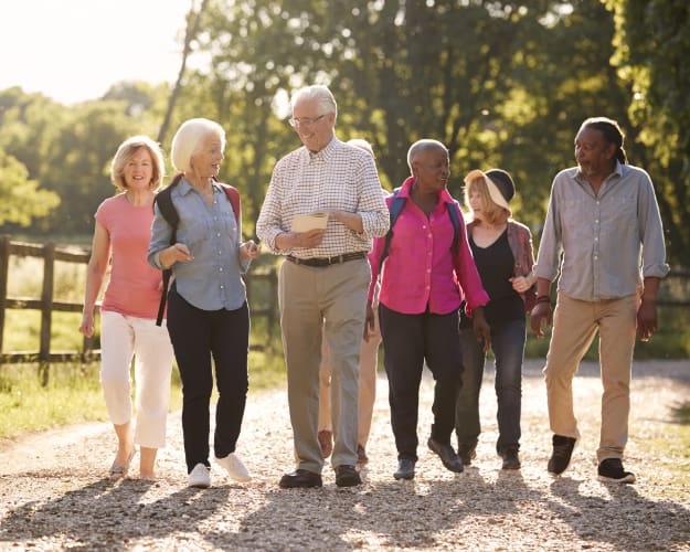 Residents walking together in a sunny outdoor path