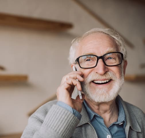 Senior man smiling on the phone in a casual setting