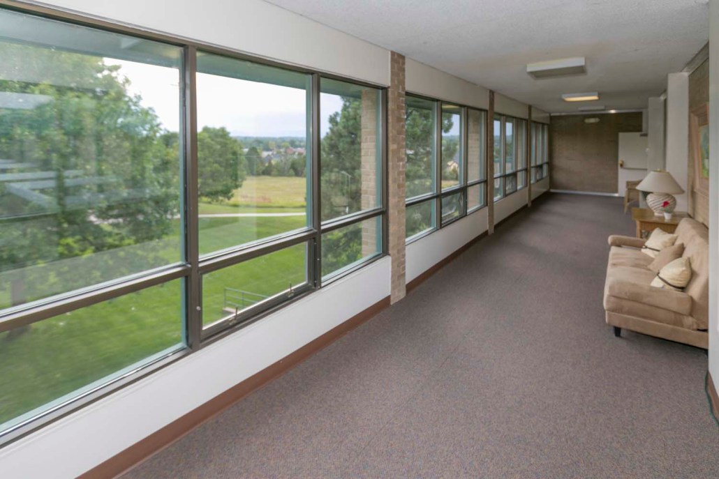 Bright corridor with large windows and seating area