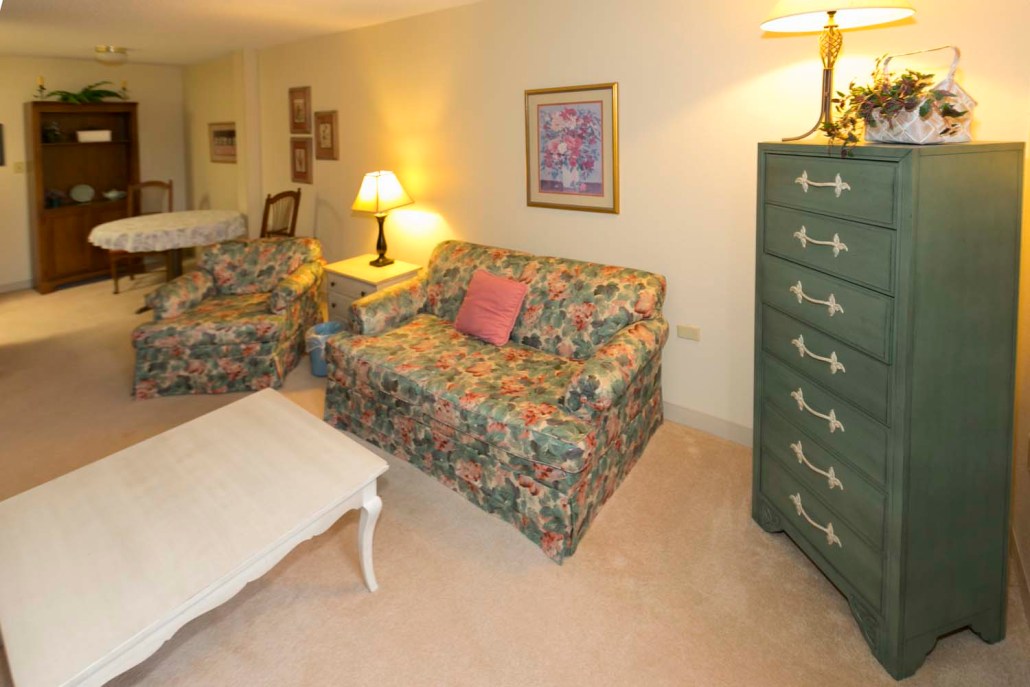 Cozy common area with floral furniture and lamp