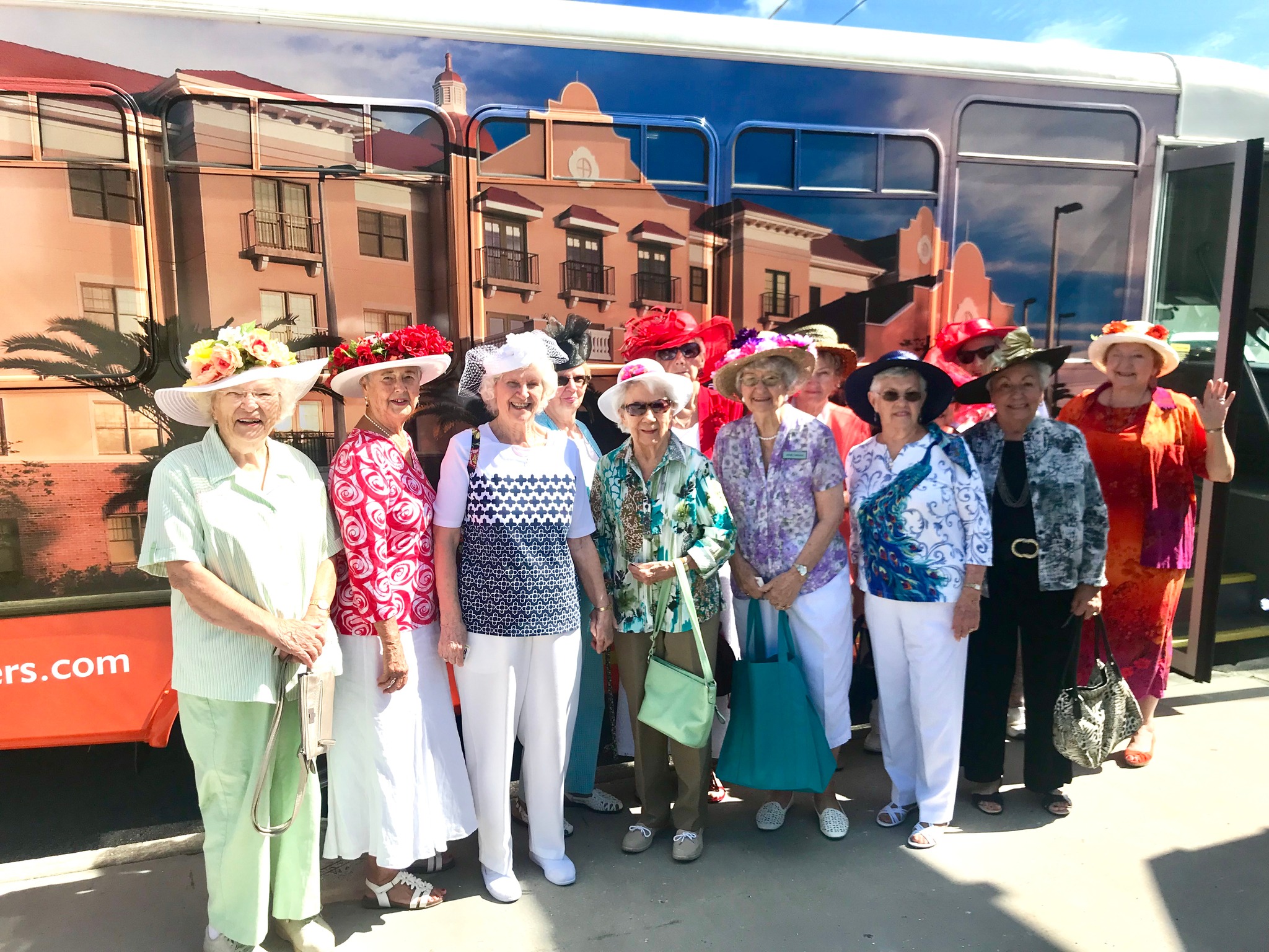 Residents dressed in hats enjoying a community outing