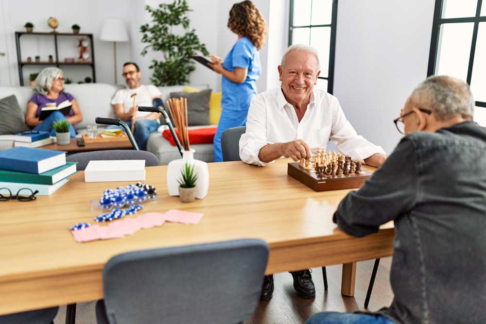 Residents playing chess in a common area