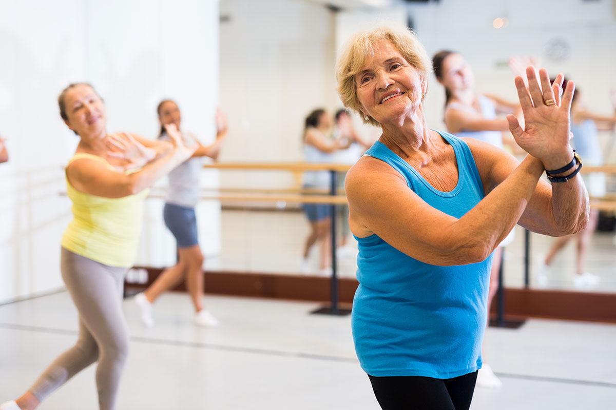 Residents participating in a dance class in a studio