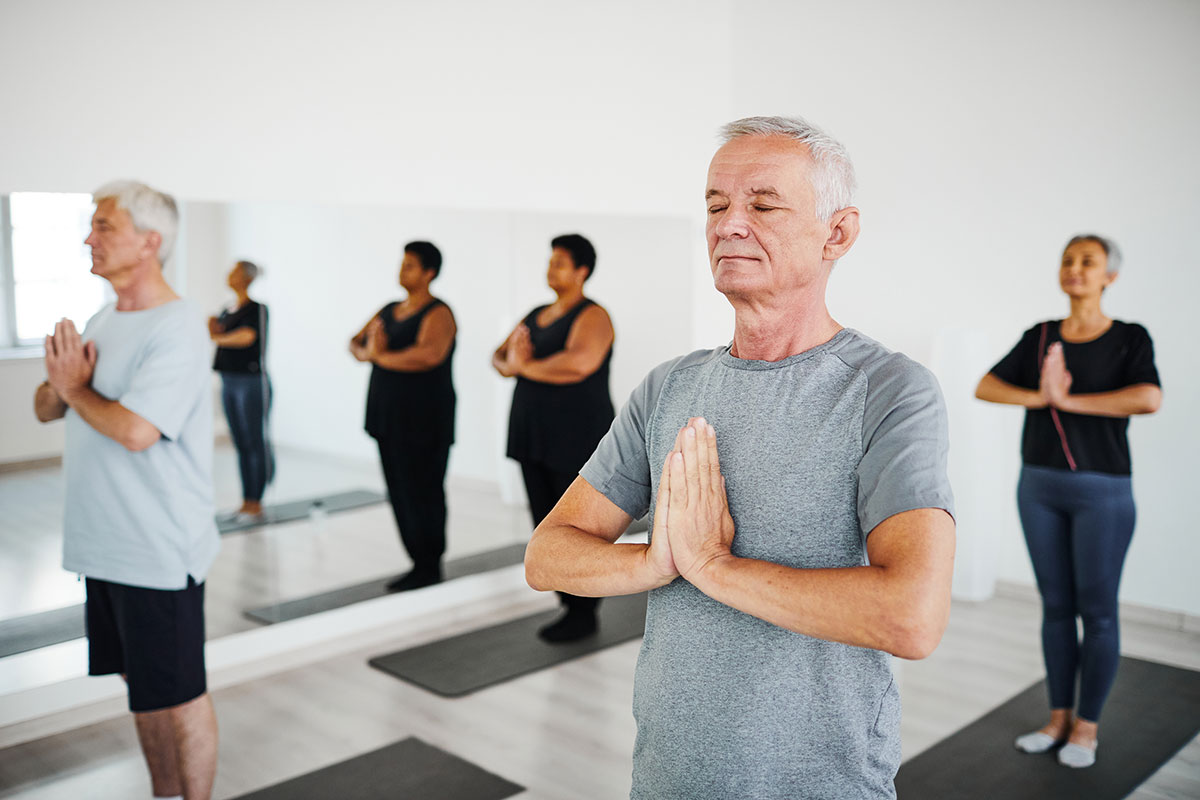 Residents participating in a yoga class in a serene setting