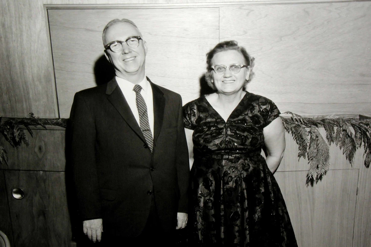 Couple posing for a photo at an indoor event