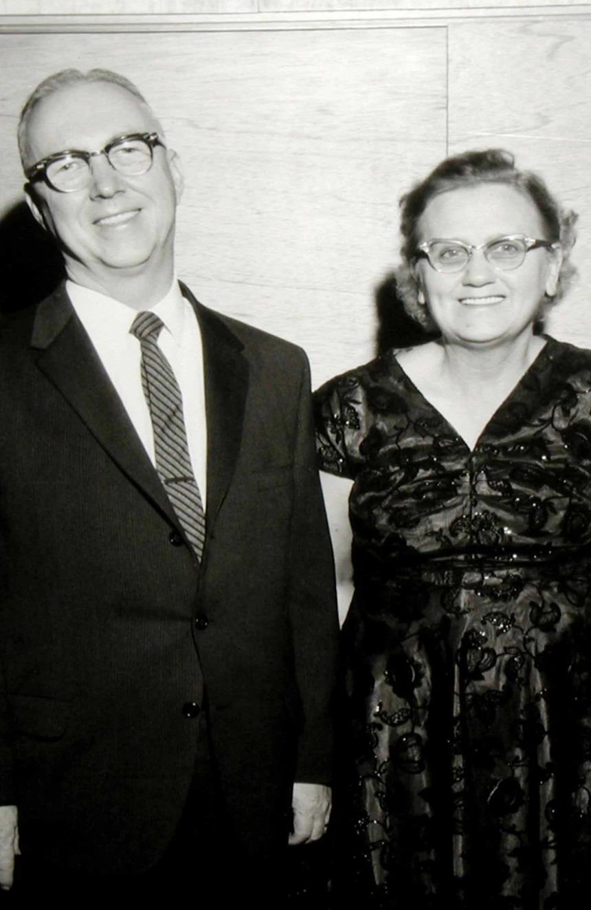 Elderly couple smiling in formal attire