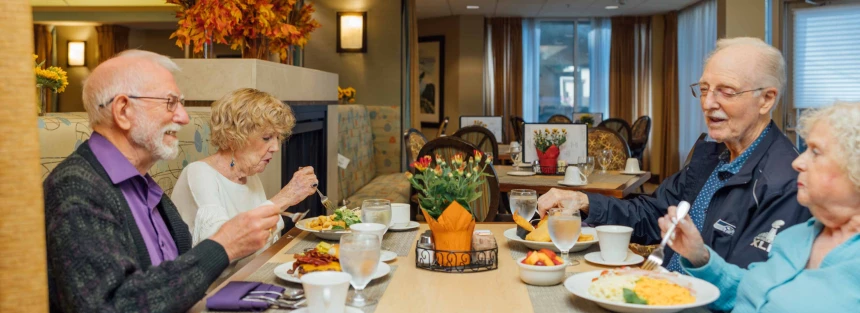 Residents enjoying a meal together in the dining room