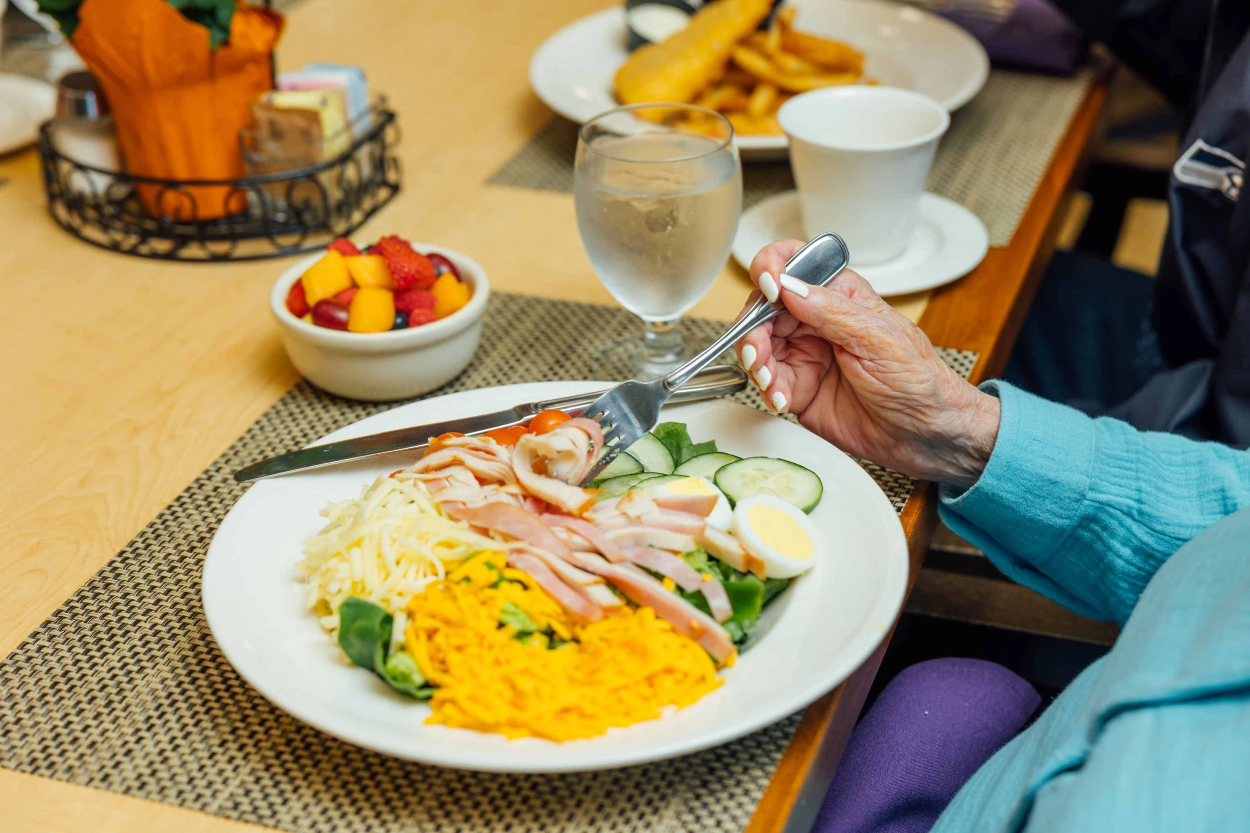 A resident enjoying a healthy meal with fresh ingredients