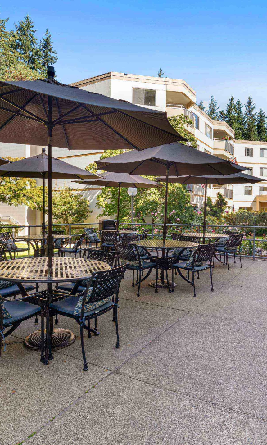 Outdoor patio area with tables and umbrellas