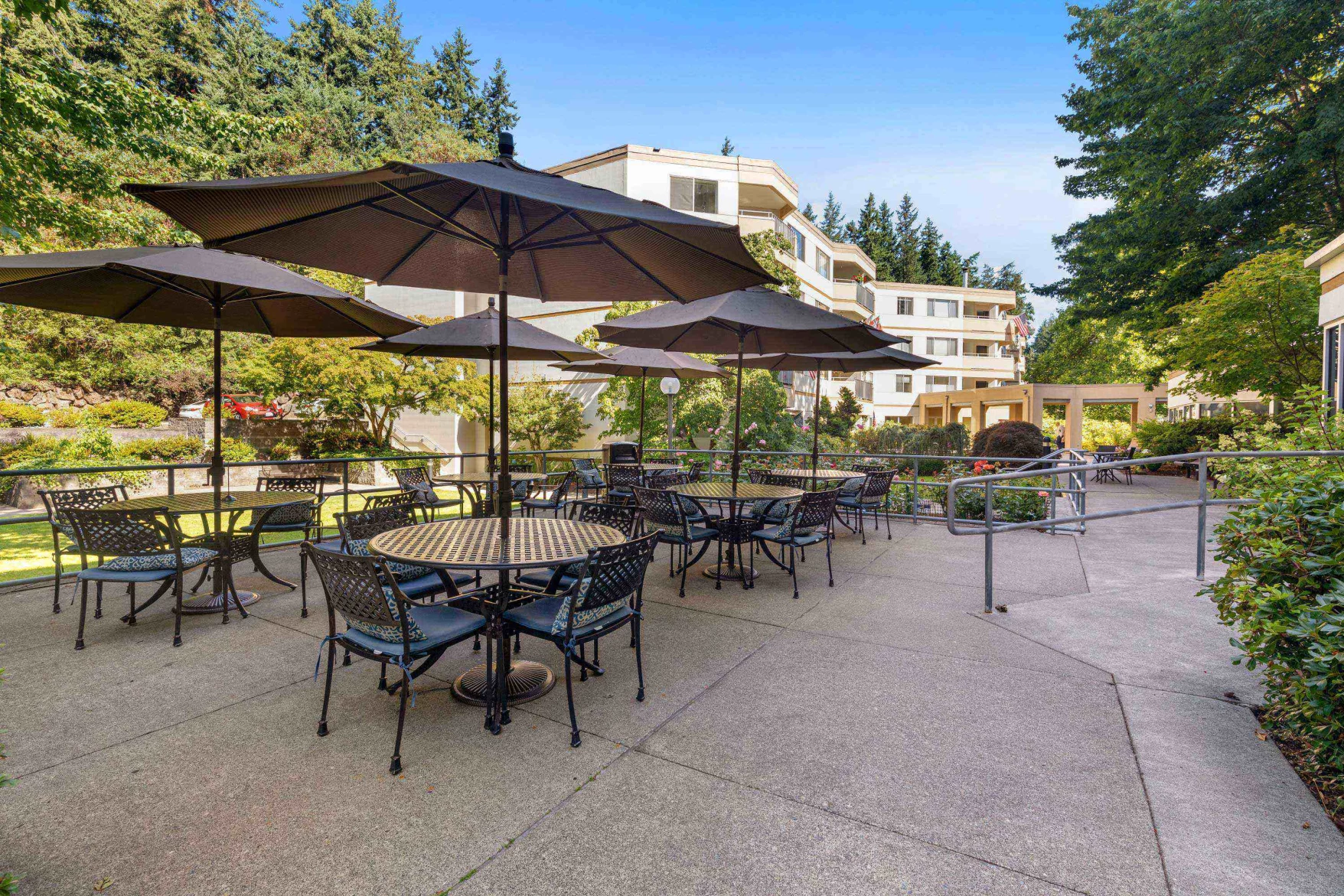 Patio area with tables and umbrellas at Cristwood
