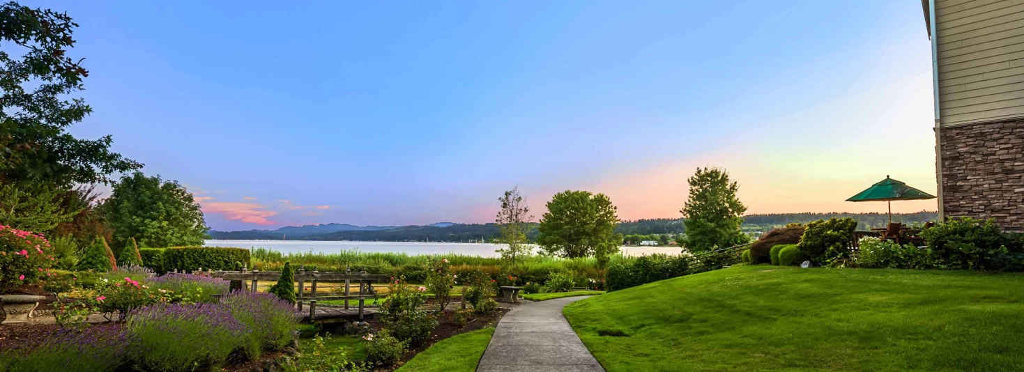 Scenic outdoor view of landscaped grounds by the lake