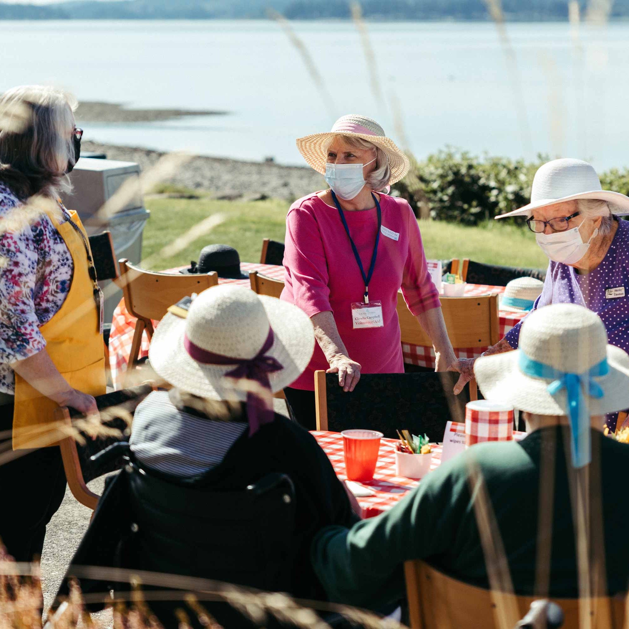Residents enjoying a picnic outdoors by the water