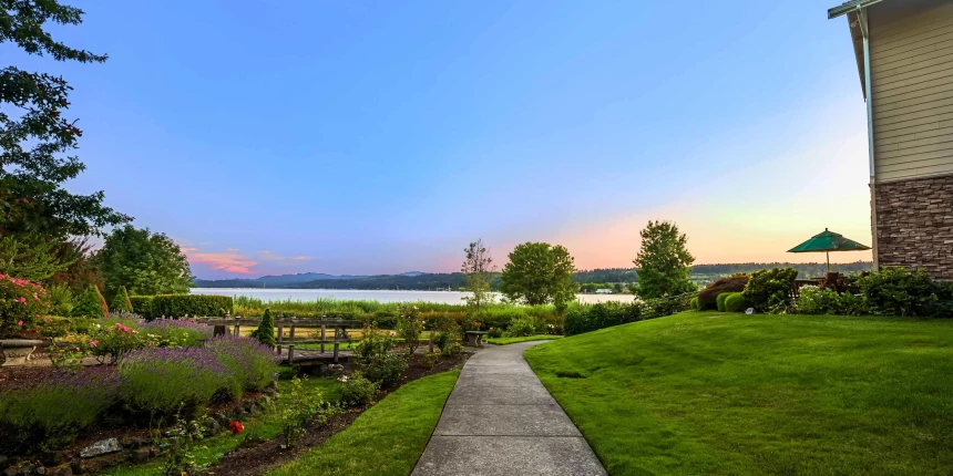 Walking path in garden with lakeside view