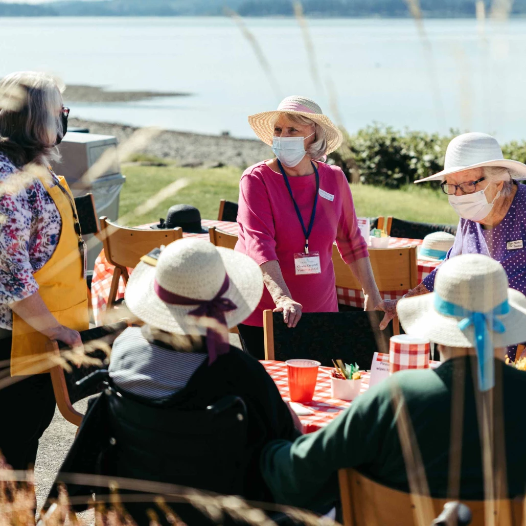 Residents interacting during an outdoor activity by the water