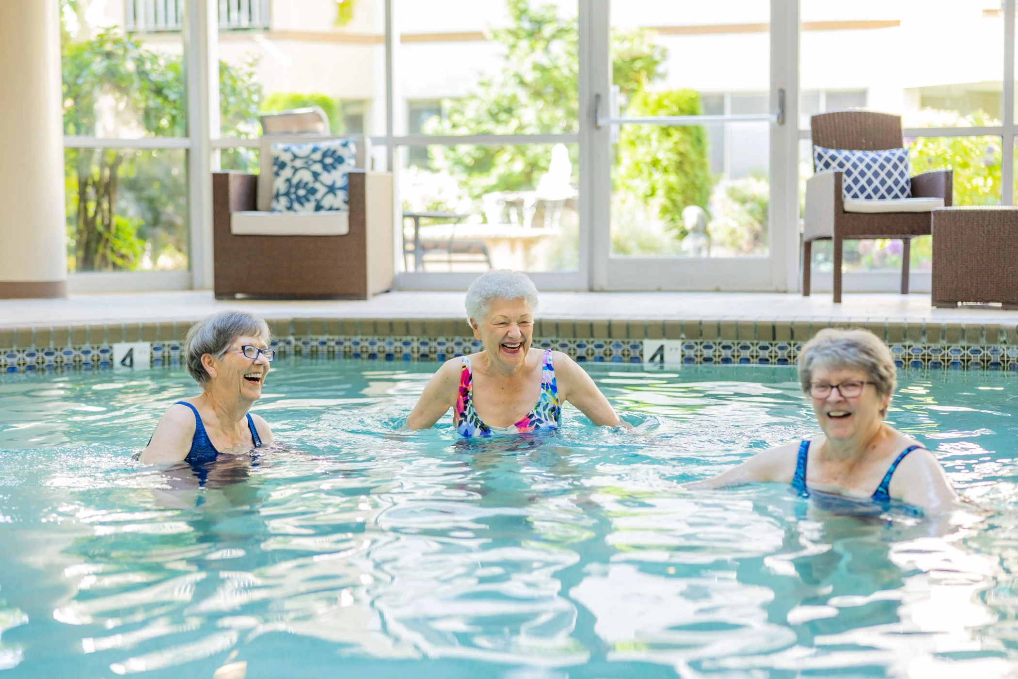 Three seniors enjoying a pool activity together