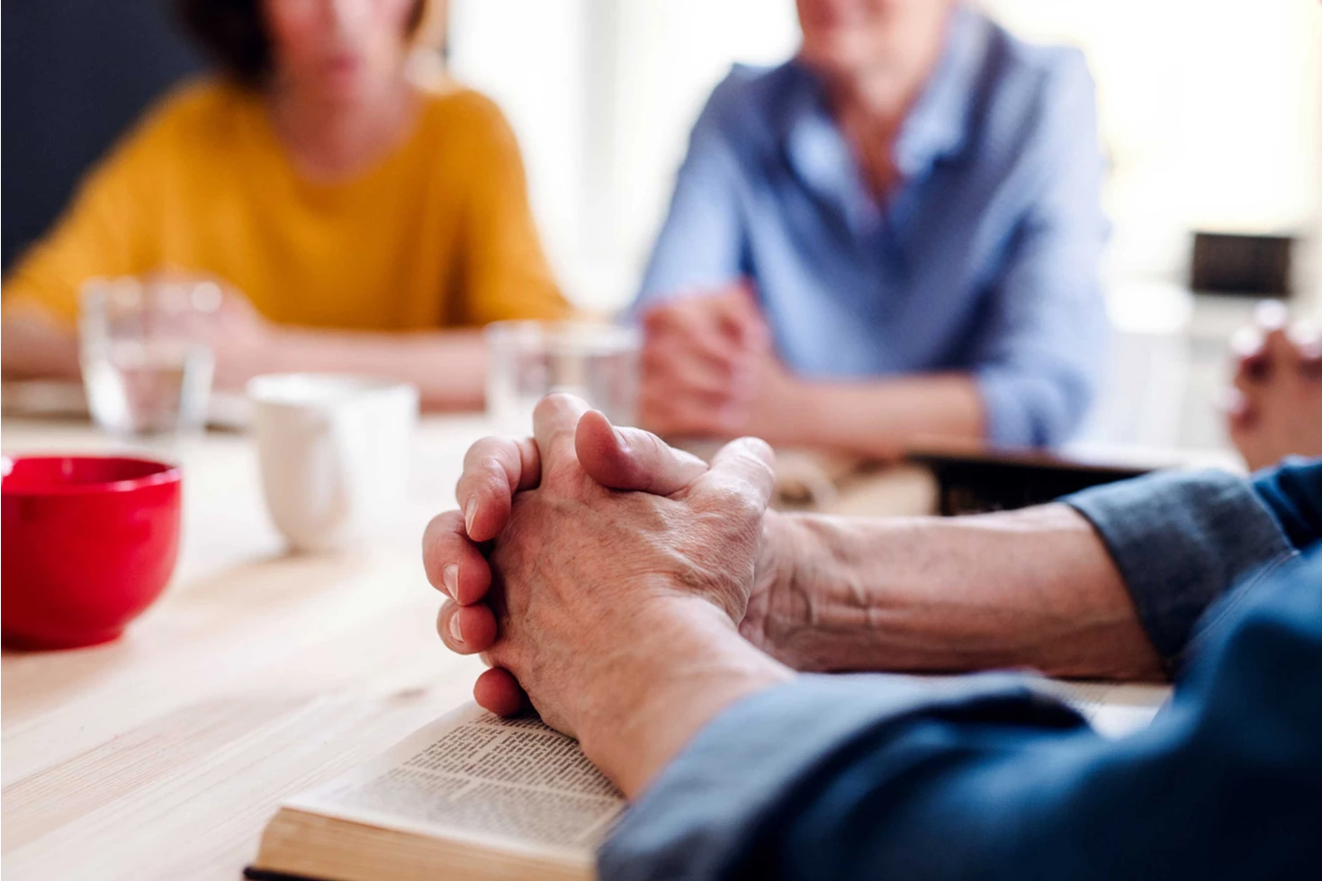 Close-up of hands during a group discussion in an indoor setting