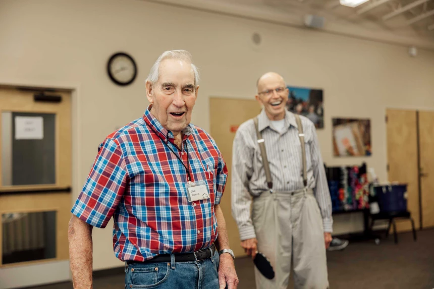 Two male residents smiling in an activity room