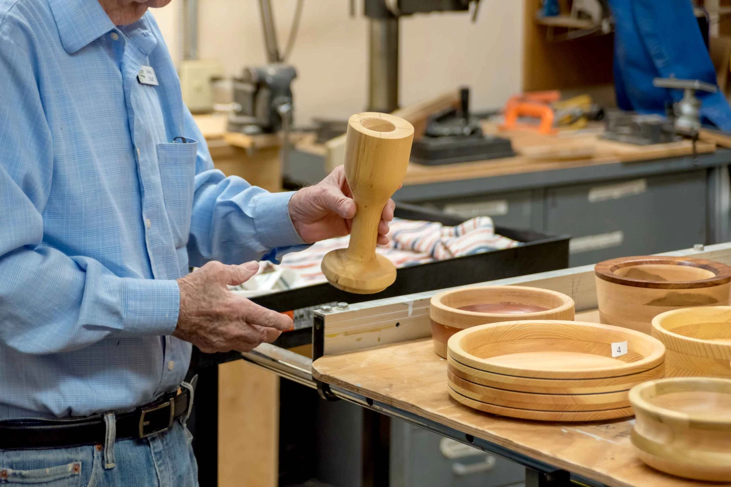 An elderly man working on woodworking projects