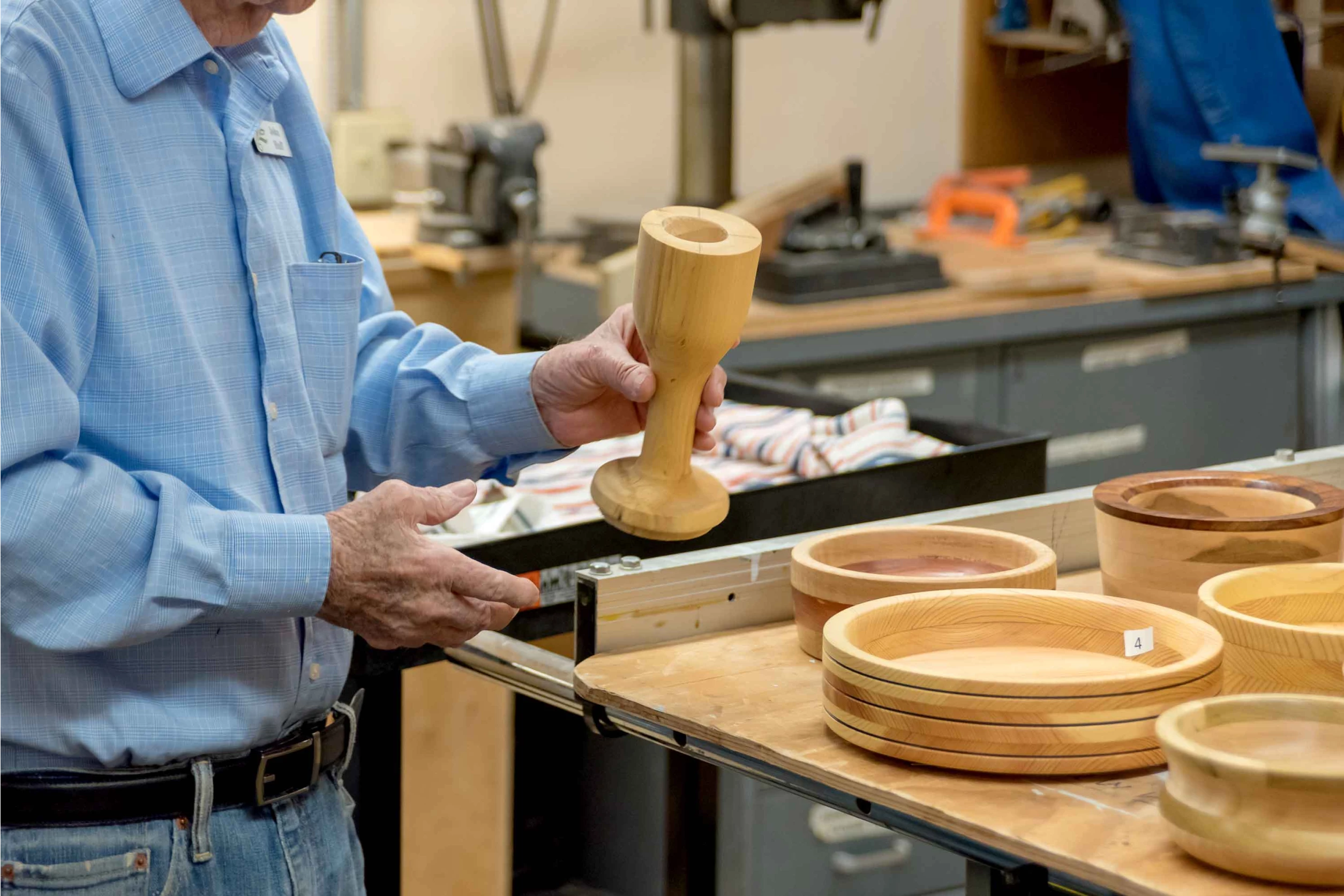 Resident crafting wooden items in the workshop