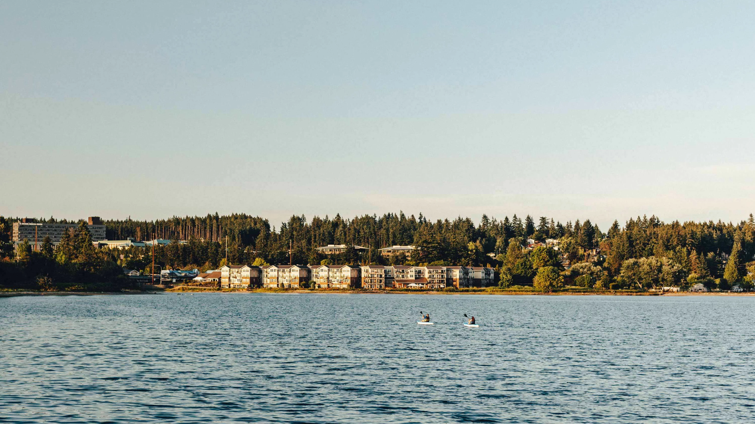 View of facility by the water with residents kayaking