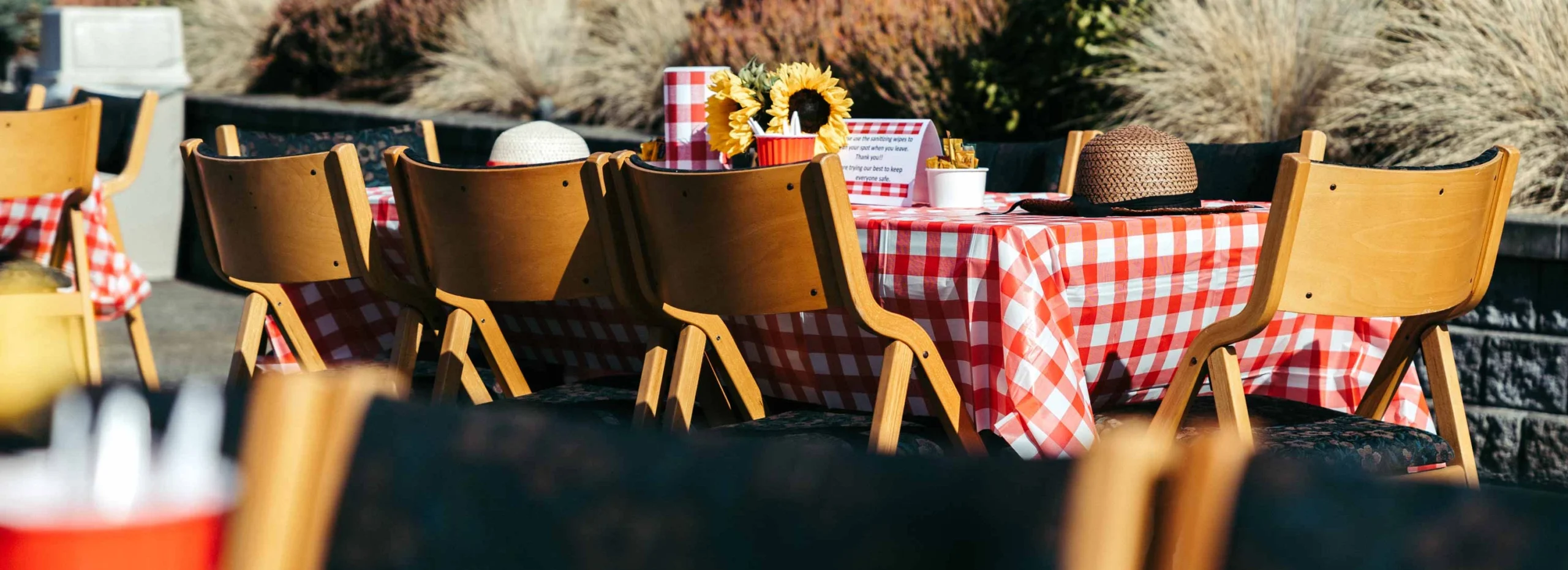 Outdoor dining setup with a checkered tablecloth and decor