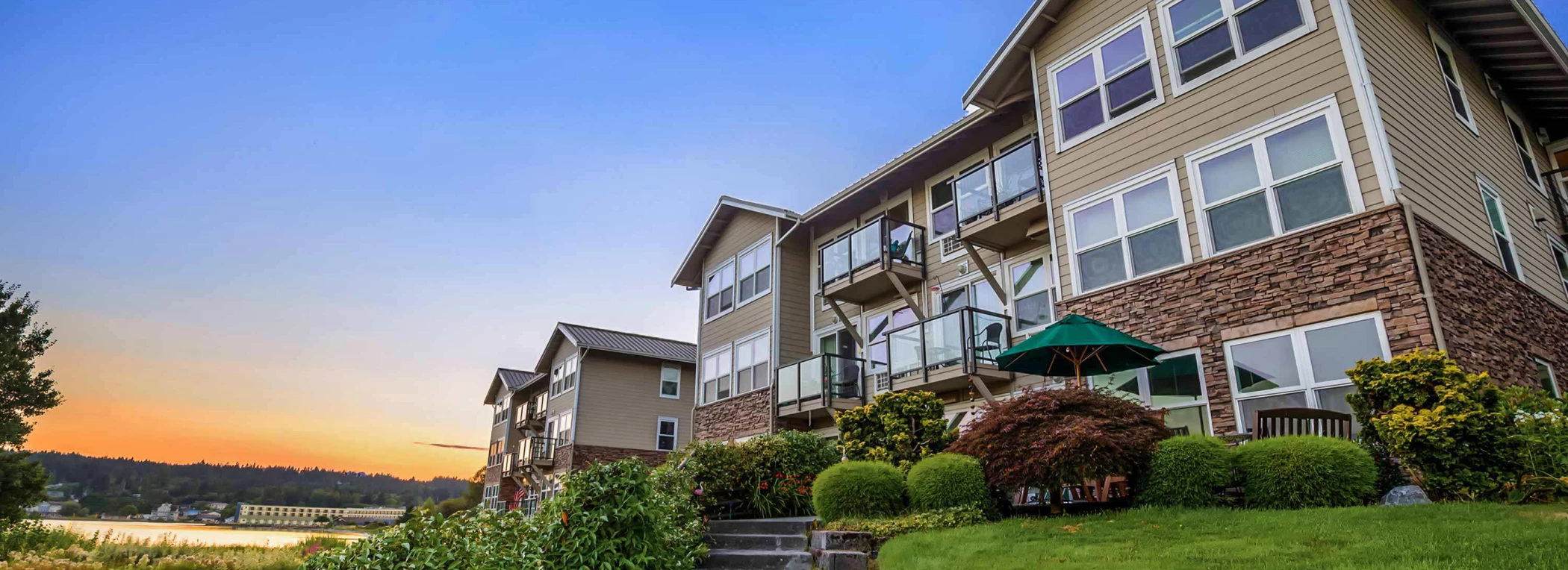 Building exterior of a senior living facility at sunset