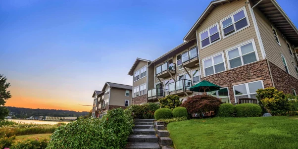 Building exterior of a senior living facility at sunset