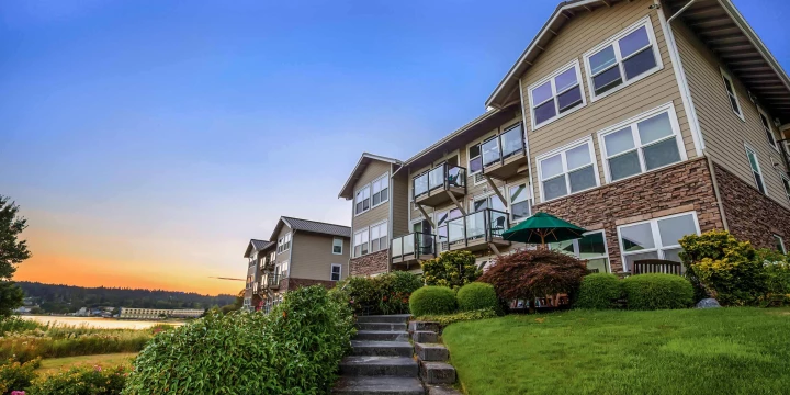 Exterior view of a senior living facility at sunset