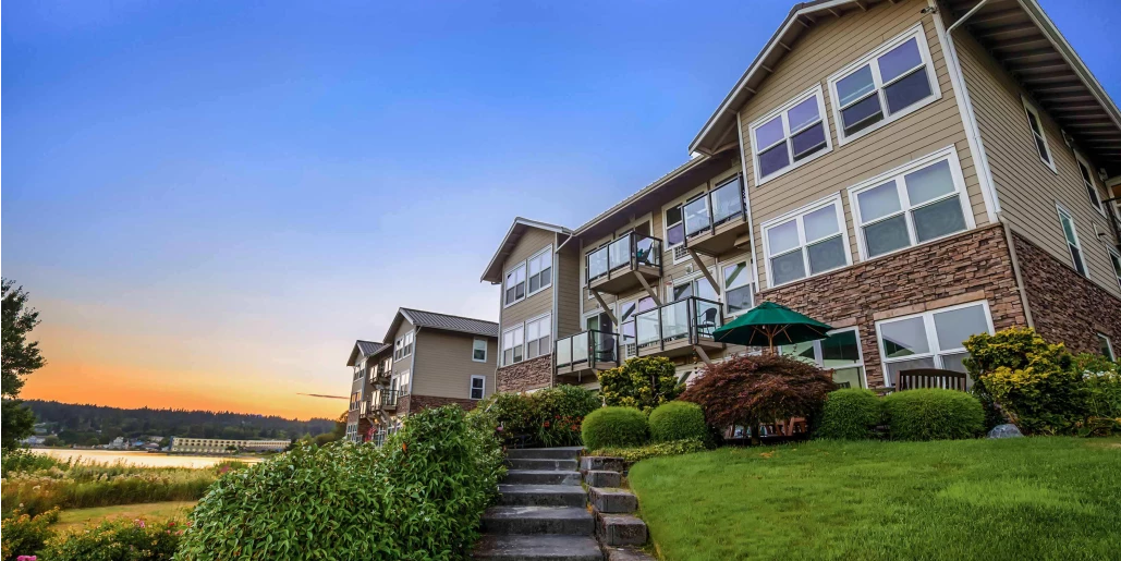 Exterior view of a senior living facility at sunset