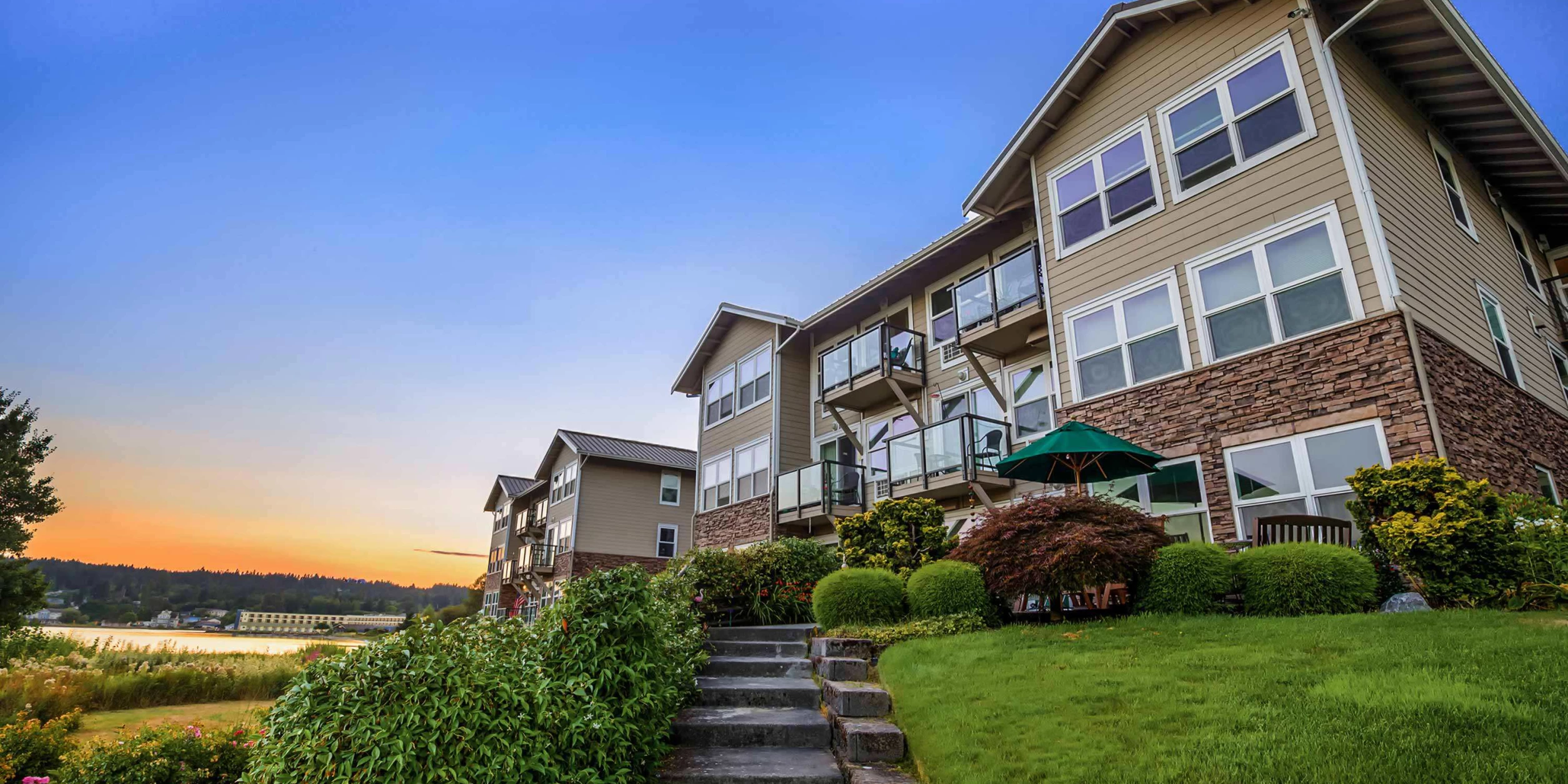 Exterior view of a senior living facility at sunset