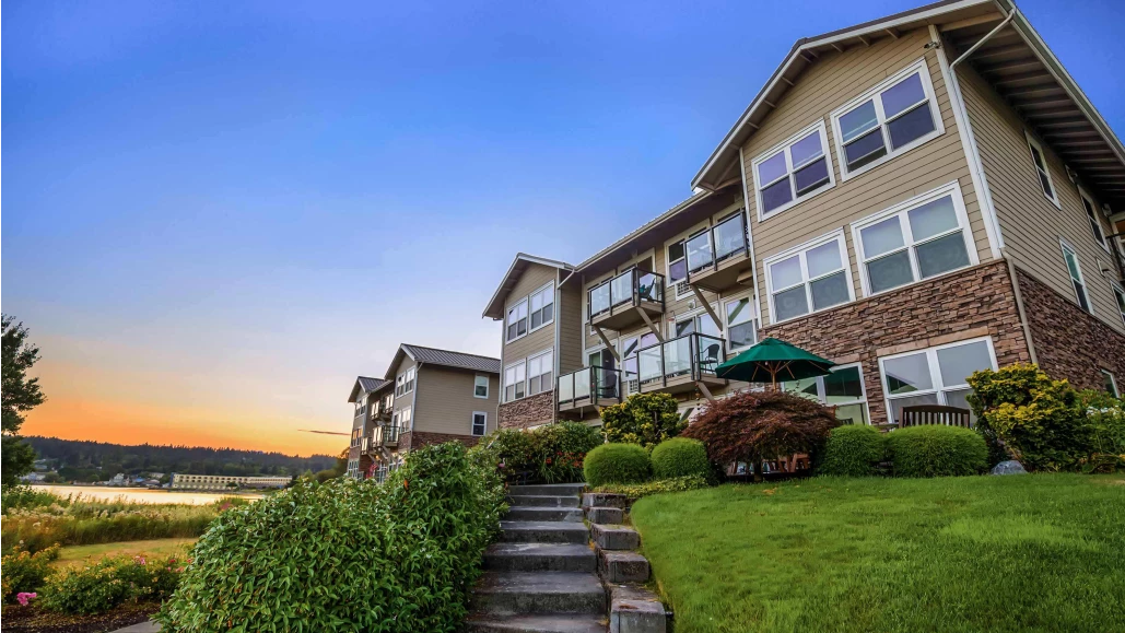 Exterior view of a senior living facility at sunset
