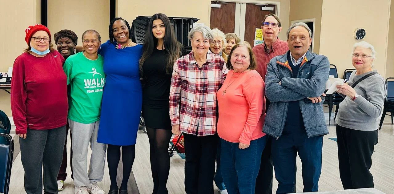 A group of residents and staff smiling together.
