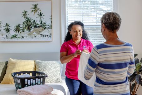 Staff member assisting a resident indoors