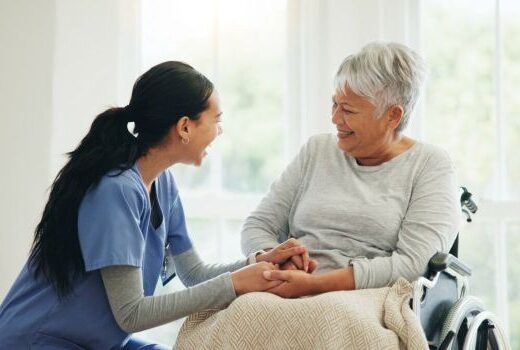 A caregiver and a resident sharing a joyful moment.