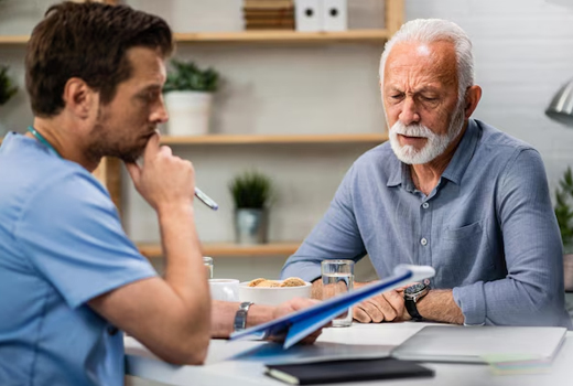 A caregiver and an elderly resident in conversation.