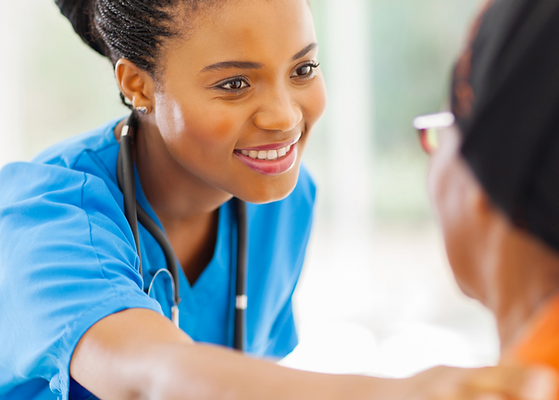 Nurse interacting warmly with a senior resident.