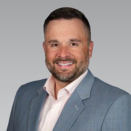 Professional headshot of a man in a suit