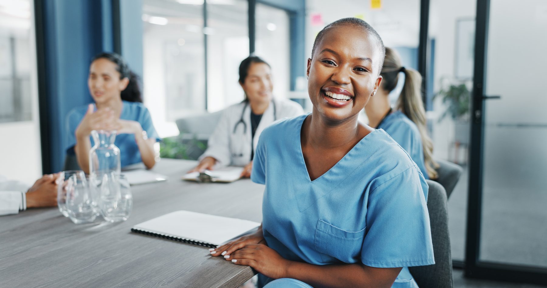 Happy healthcare staff in a meeting room.