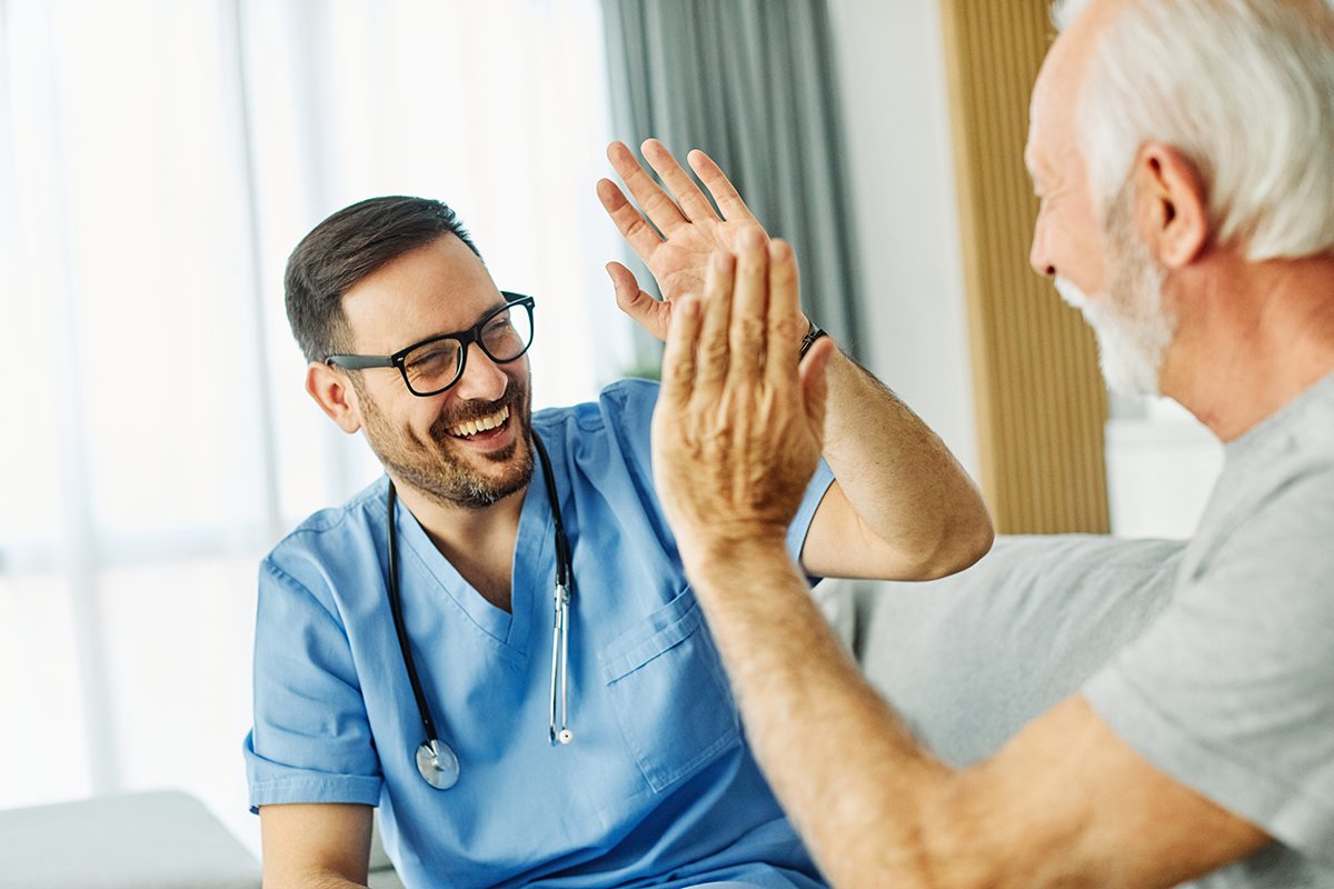 Nurse interacting happily with an elderly man