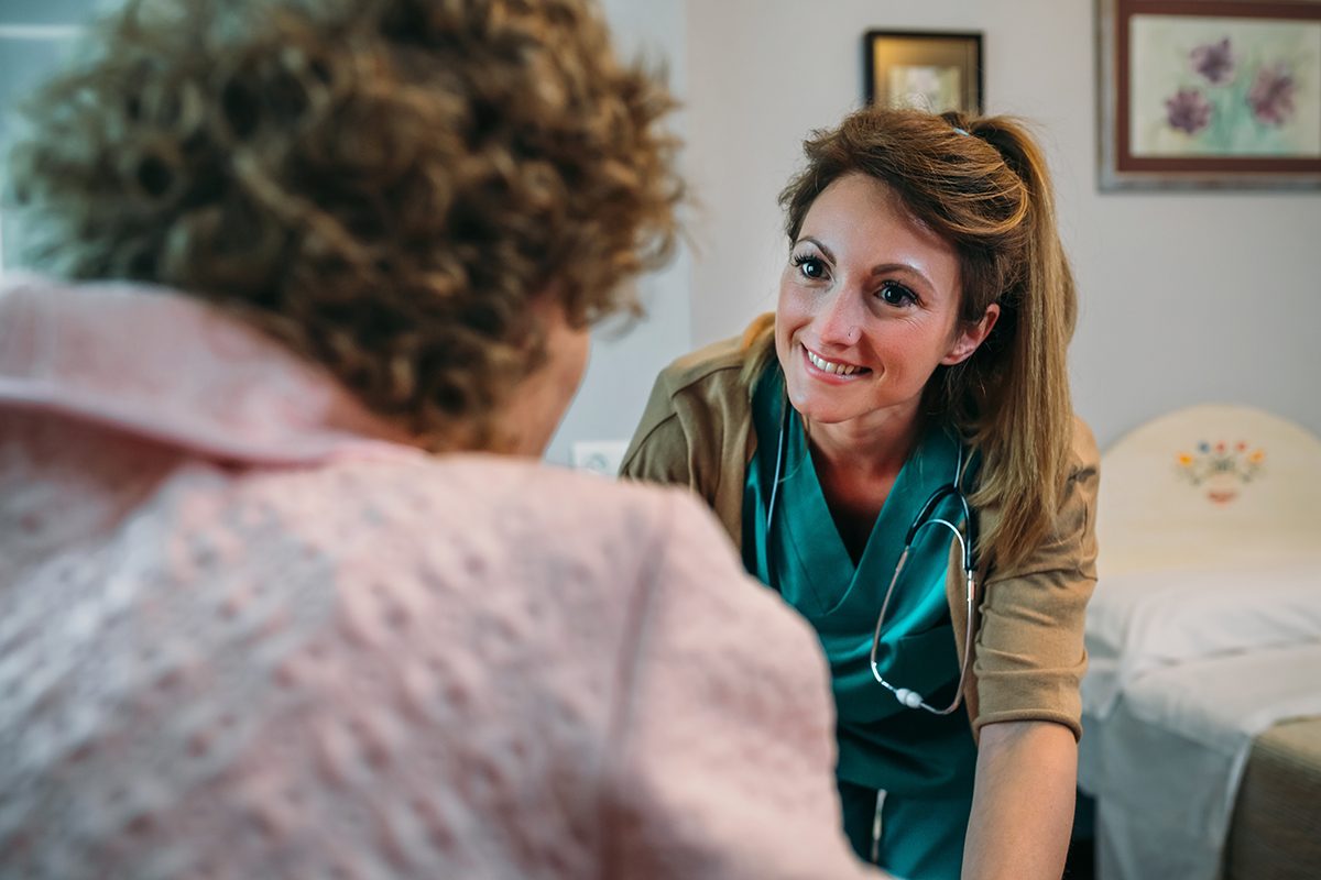Caregiver assisting a resident in a caring environment.